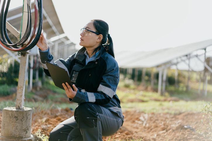 Asian female engineer working with tablet at solar power station